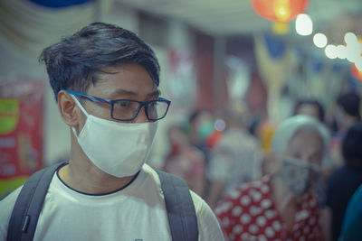 Close-up of man wearing mask looking away