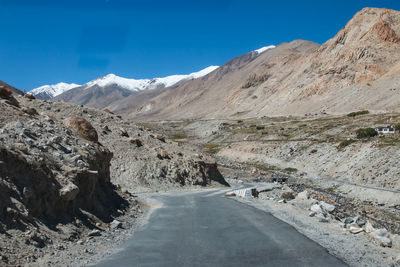 Scenic view of snowcapped mountains against blue sky