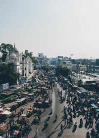 High angle view of crowd in city against clear sky