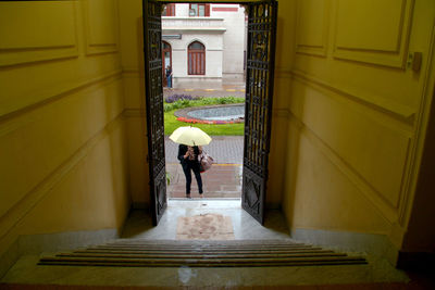 Woman looking at entrance of building