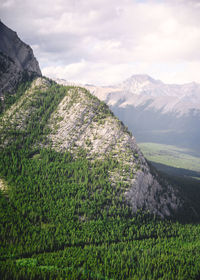 Scenic view of land and mountains against sky