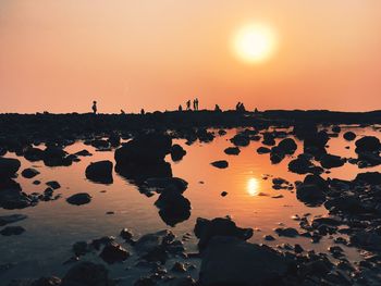 Scenic view of sea against orange sky