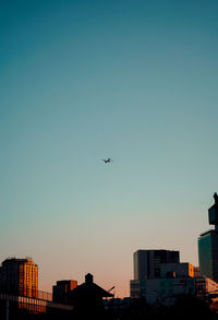 Low angle view of buildings against sky during sunset