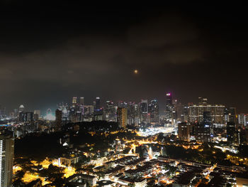 Illuminated cityscape against sky at night