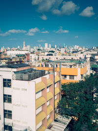 High angle view of buildings against blue sky