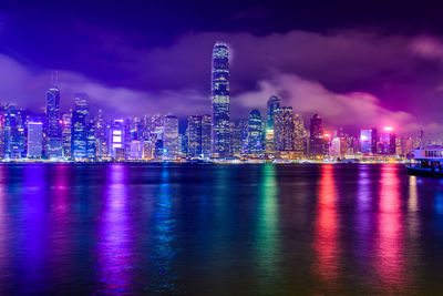 Illuminated buildings against sky at night