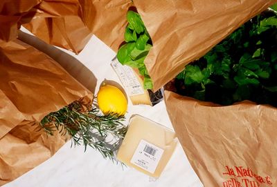 High angle view of fruits and leaves on table