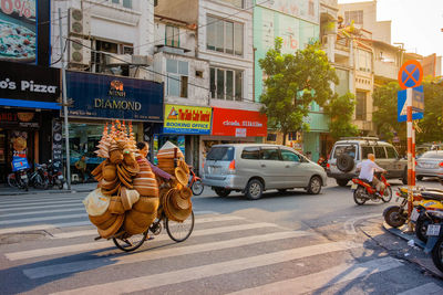 Vehicles on road against buildings