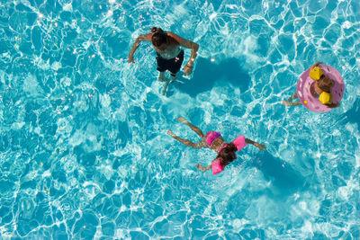 High angle view of family swimming in pool