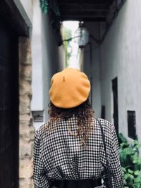 Rear view of woman wearing beige beret