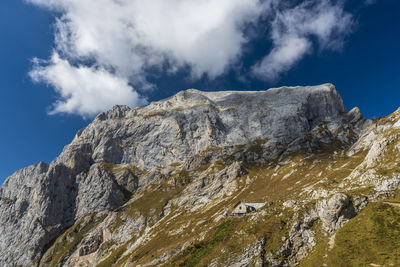 Low angle view of rocky mountains against sky