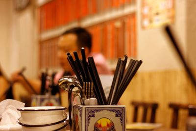 Close-up of cutleries in container at restaurant