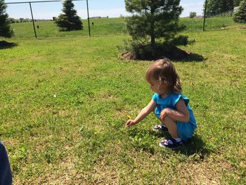 Girl picking up flower