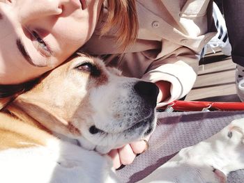 Close-up of woman relaxing with dog at home