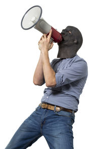 Low angle view of man photographing against white background