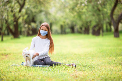 Woman with dog on field