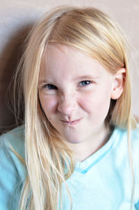 Close-up portrait of girl against wall