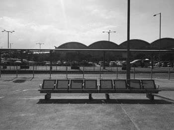 Railing by water against sky