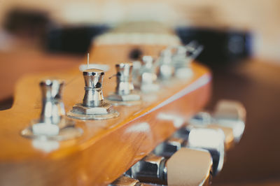 Close-up of electric guitar tuning pegs on table