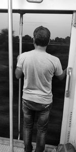 Rear view of boy standing outdoors