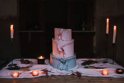 Close-up of illuminated candles on table