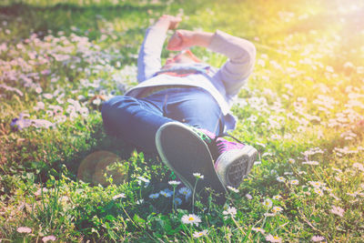 Low section of person lying on field