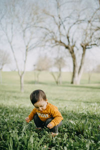 Rear view of boy on field