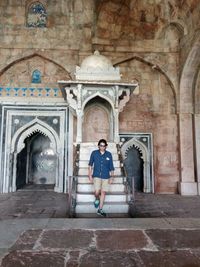 Full length of a man standing outside temple