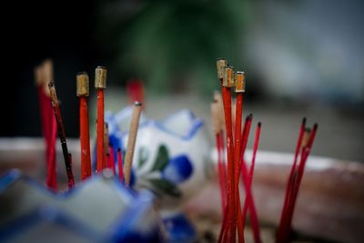 Close-up of paintbrushes in temple