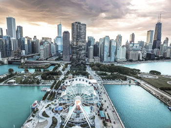 Aerial view of modern buildings against cloudy sky