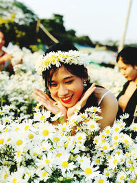 Portrait of smiling woman with yellow flower