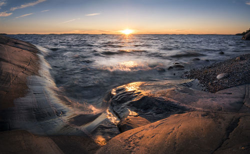 Close-up of sea against sky during sunset