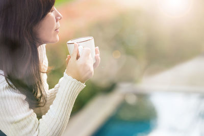 Close-up of young woman drinking coffee