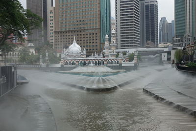 Fountain in city buildings during rainy season
