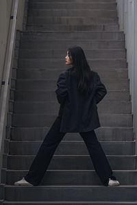 Rear view of woman standing in building