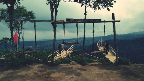 Swing at playground against sky