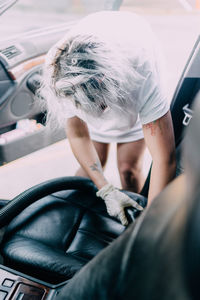 Portrait of woman holding a car