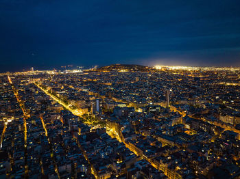 Aerial view of illuminated cityscape against sky