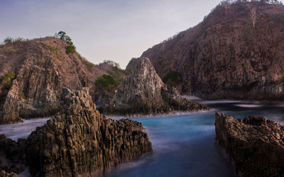 Scenic view of sea and mountains against sky