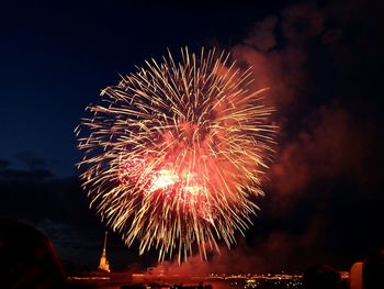 Low angle view of firework display at night