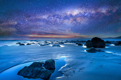 Scenic view of sea against sky at night