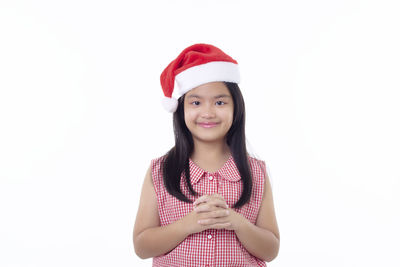 Portrait of a smiling young woman against white background