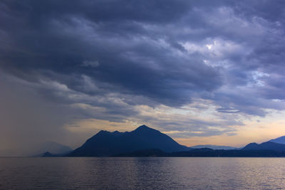 Calm lake against mountain range