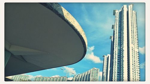 Low angle view of modern building against blue sky