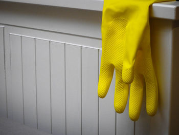 Close-up of clothes drying against yellow wall