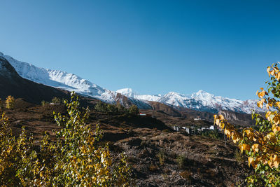 Scenic view of mountains against clear blue sky