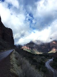 Road passing through mountains against sky