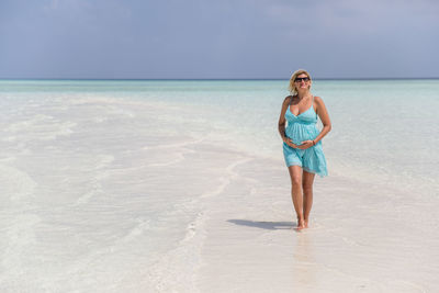 Pregnant woman on beach