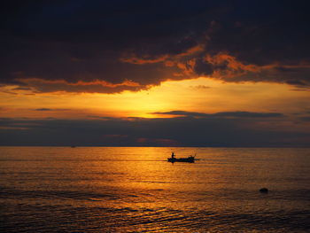 Scenic view of sea against orange sky