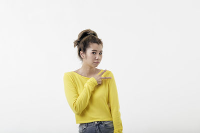 Portrait of a smiling young woman against white background